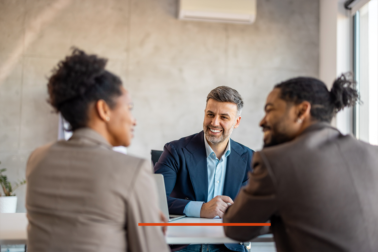 Skelton Moore lawyer talking to two clients across the table